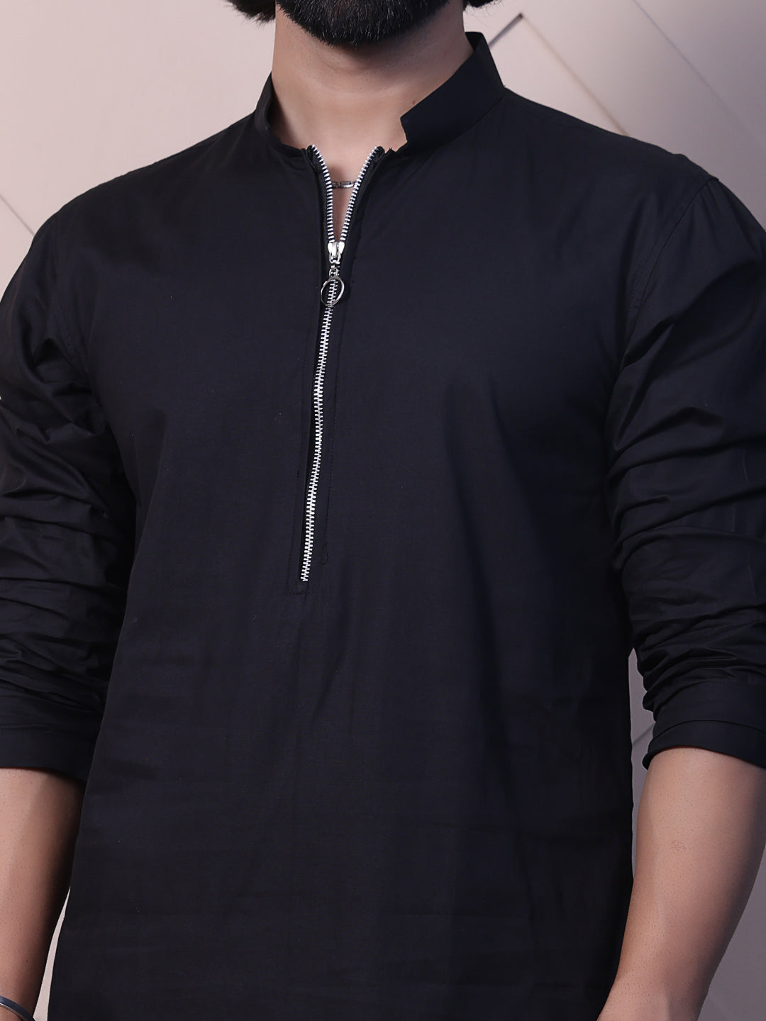 Black kurta with a rounded hem and zip closure